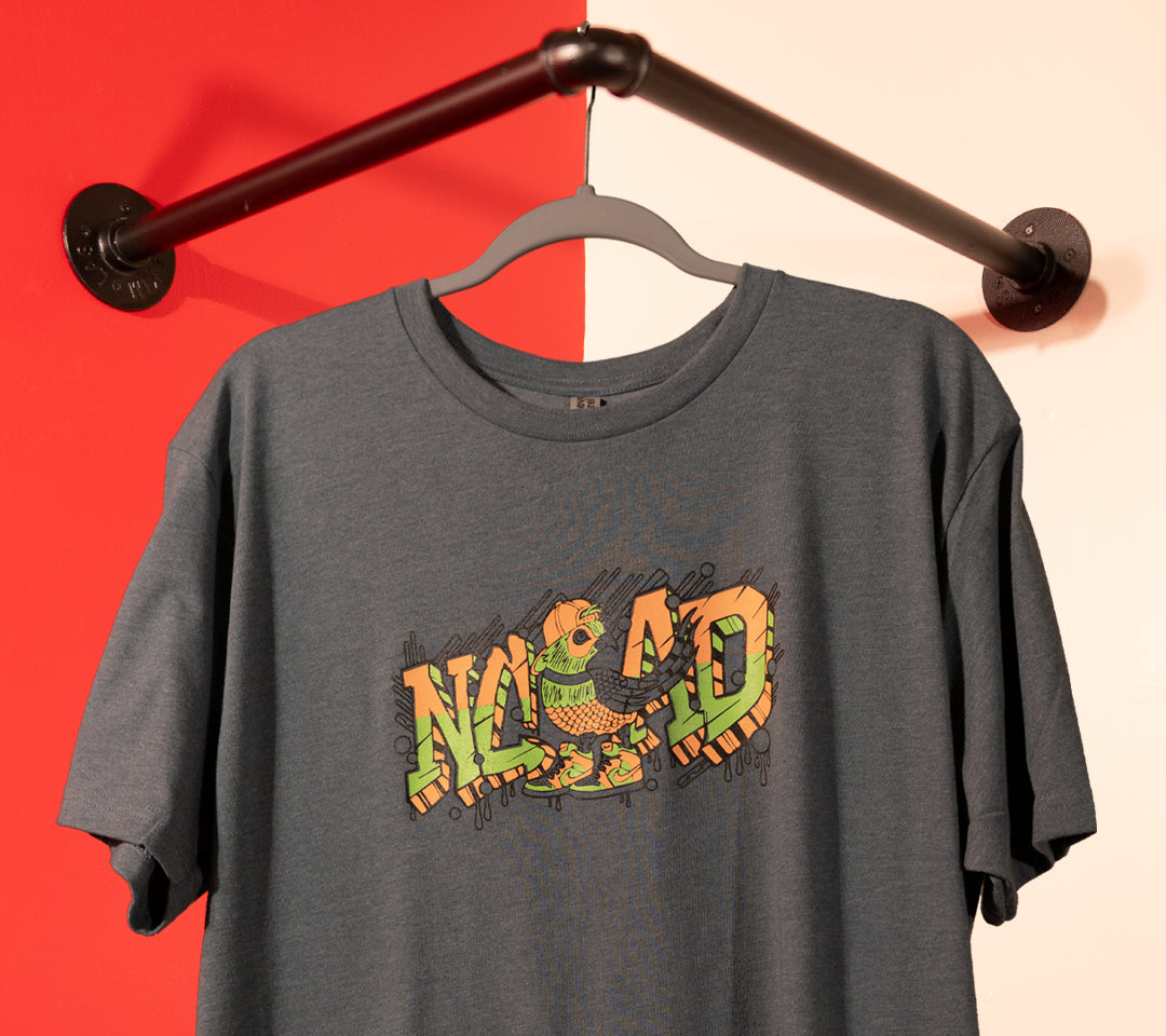 custom screen printed NCAD t-shirt with detailed multi-color graphic, example of high-quality apparel printing by Sundays Screen Printing, a Washington screen printing shop serving small businesses and clothing brands